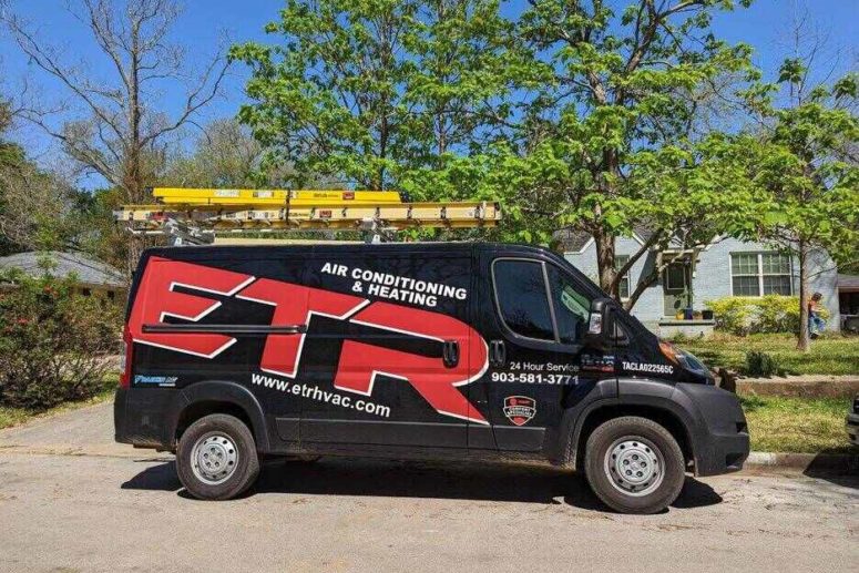 hvac system repair truck in front of a house