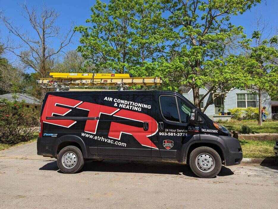 hvac system repair truck in front of a house